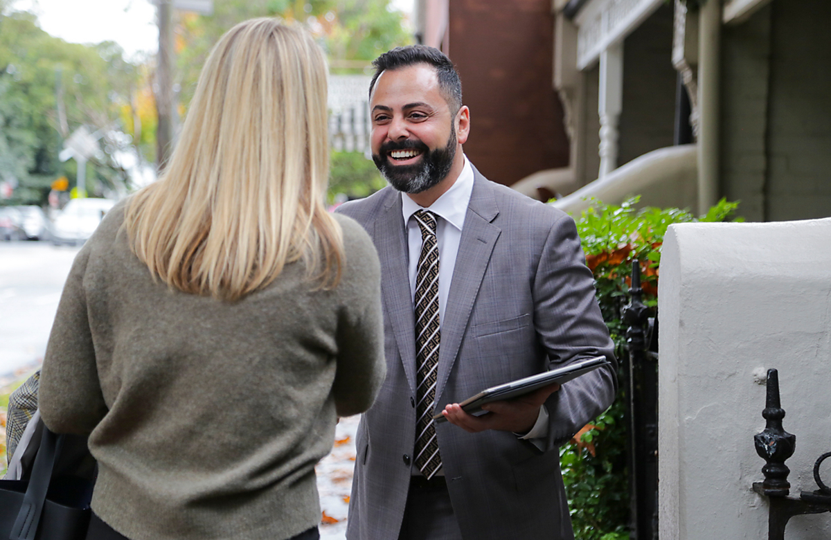 Real Estate agent greeting client outside her home